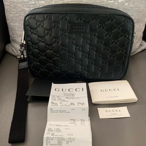 Gucci GG embossed wrist strap bag
